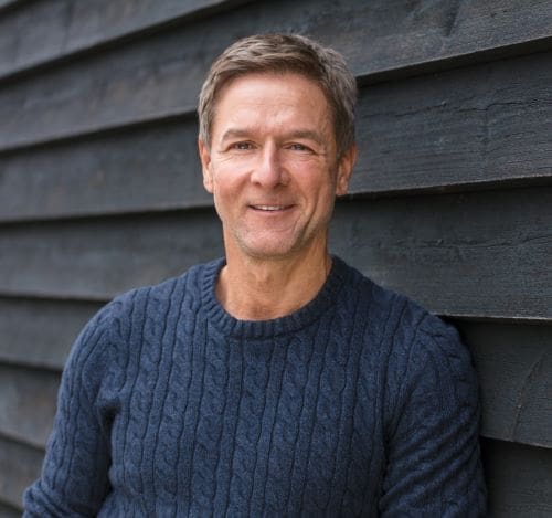 man leaning against wall confidently